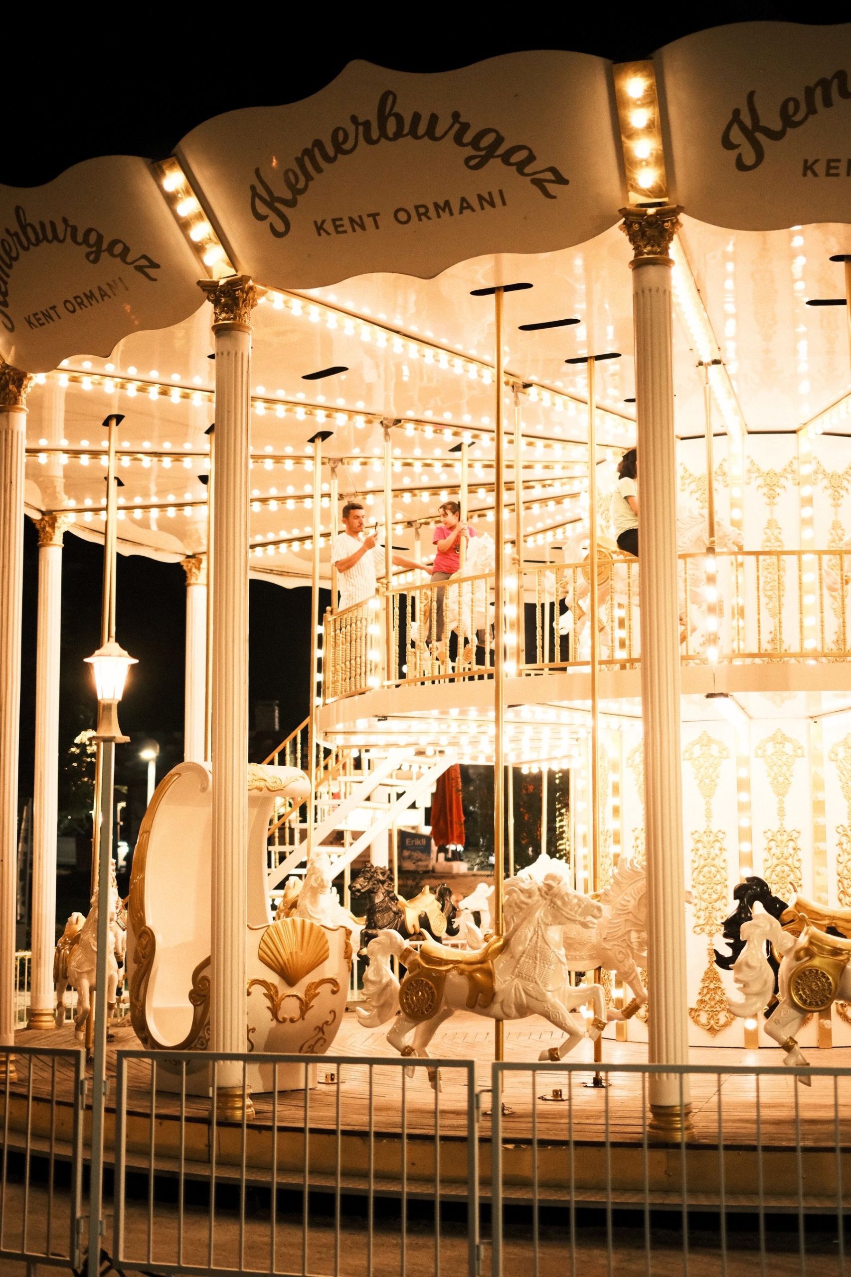 A glowing vintage carousel with carved horses