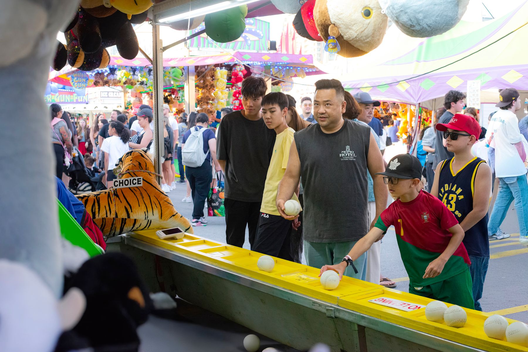 A family laughing together at a carnival game