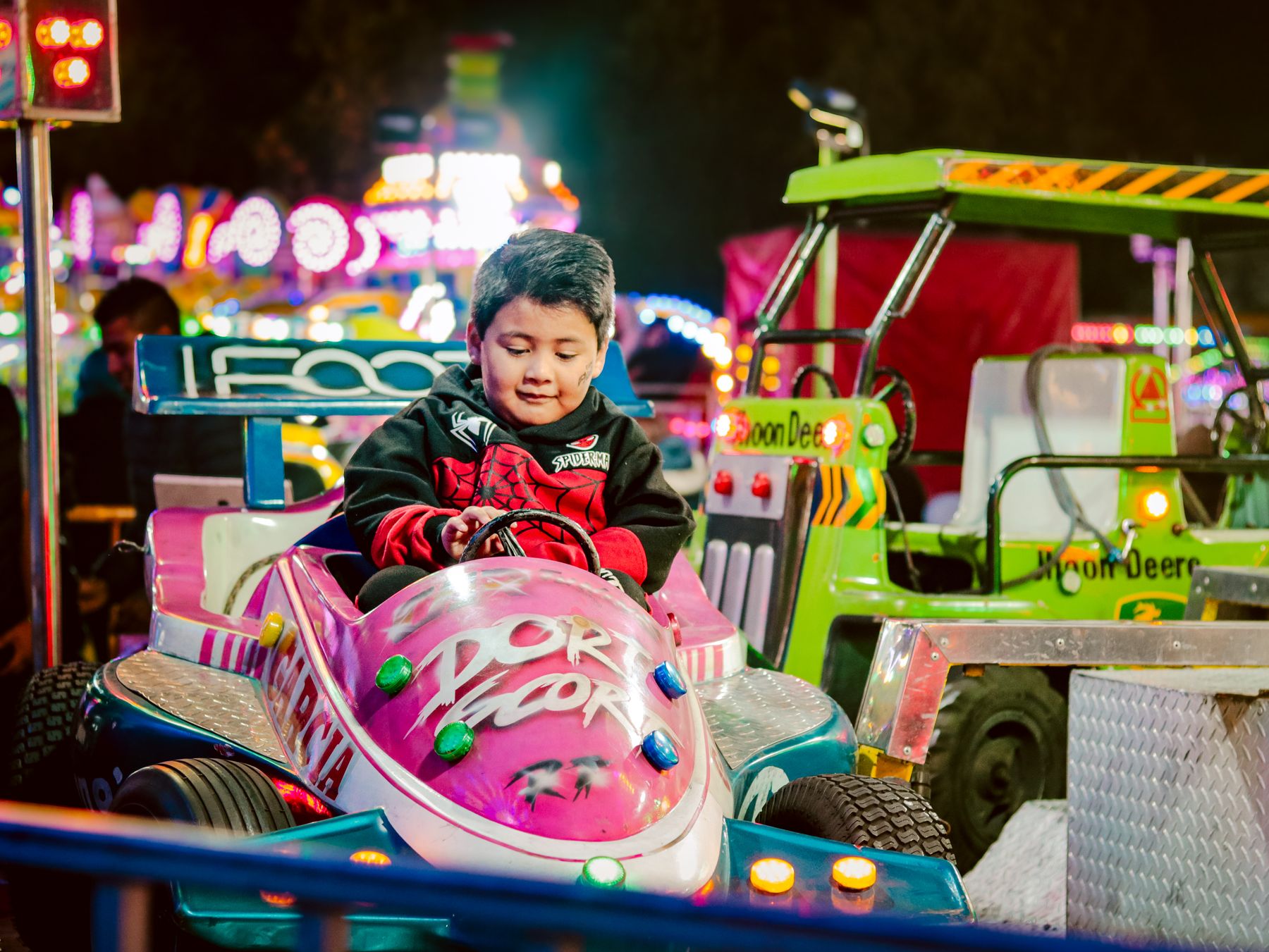 A child driving a bumper car at a fair