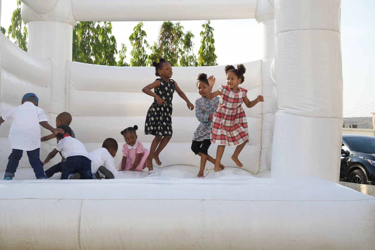Kids jumping in a white modern bounce house