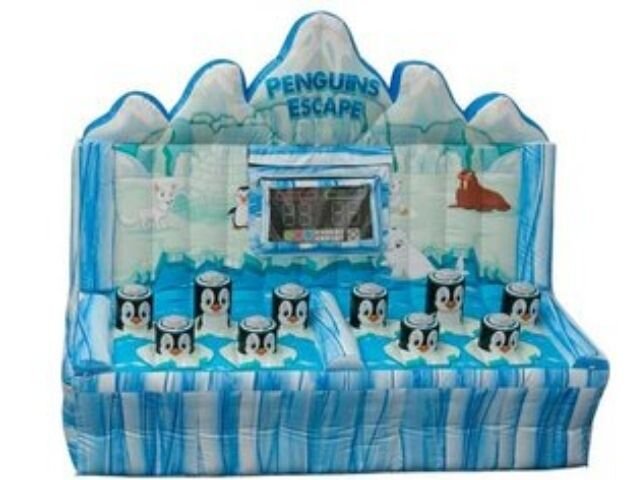 A penguin-themed inflatable carnival game