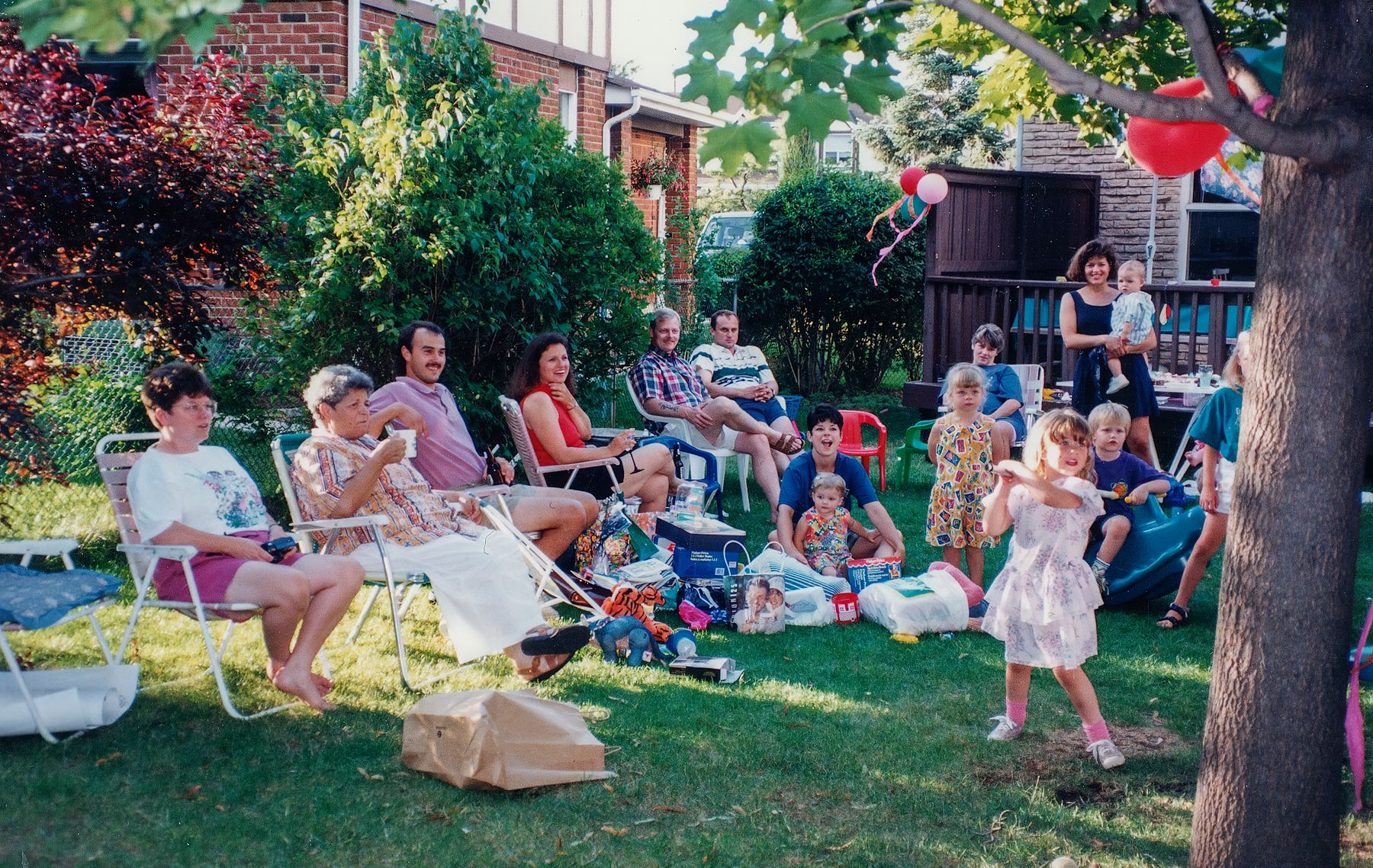Families gathered on a lawn at a neighborhood party